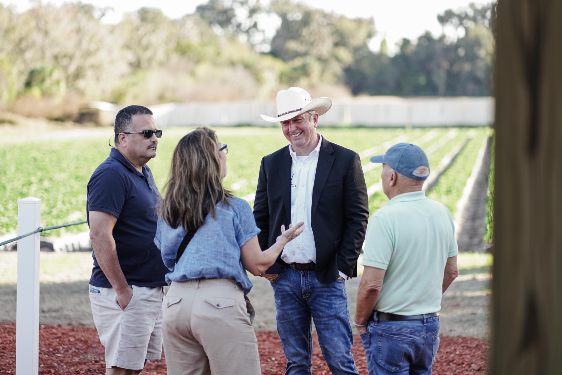 Bobby Williams speaking with Floridians near agricultural land.